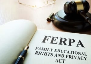 Law textbook with the words "FERPA" on the front page. A gavel is behind the picture on the desk.